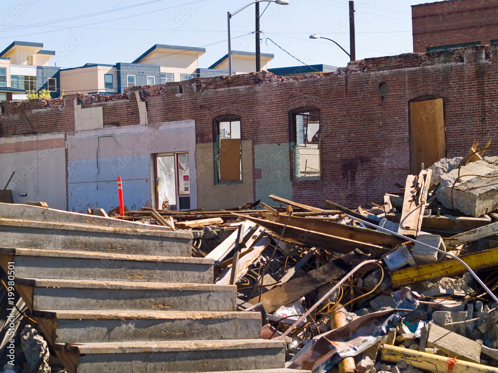 A demolition site with a pile of brick wall and concrete debris