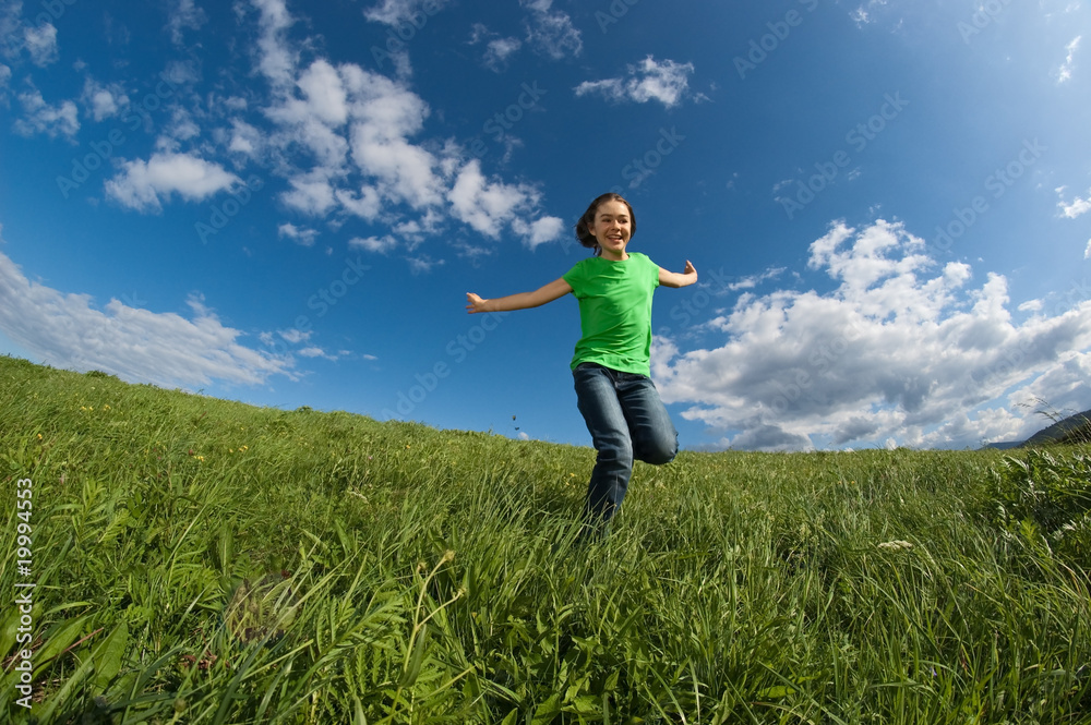 Girl jumping, running against blue sky Girl jumping, running against blue sky