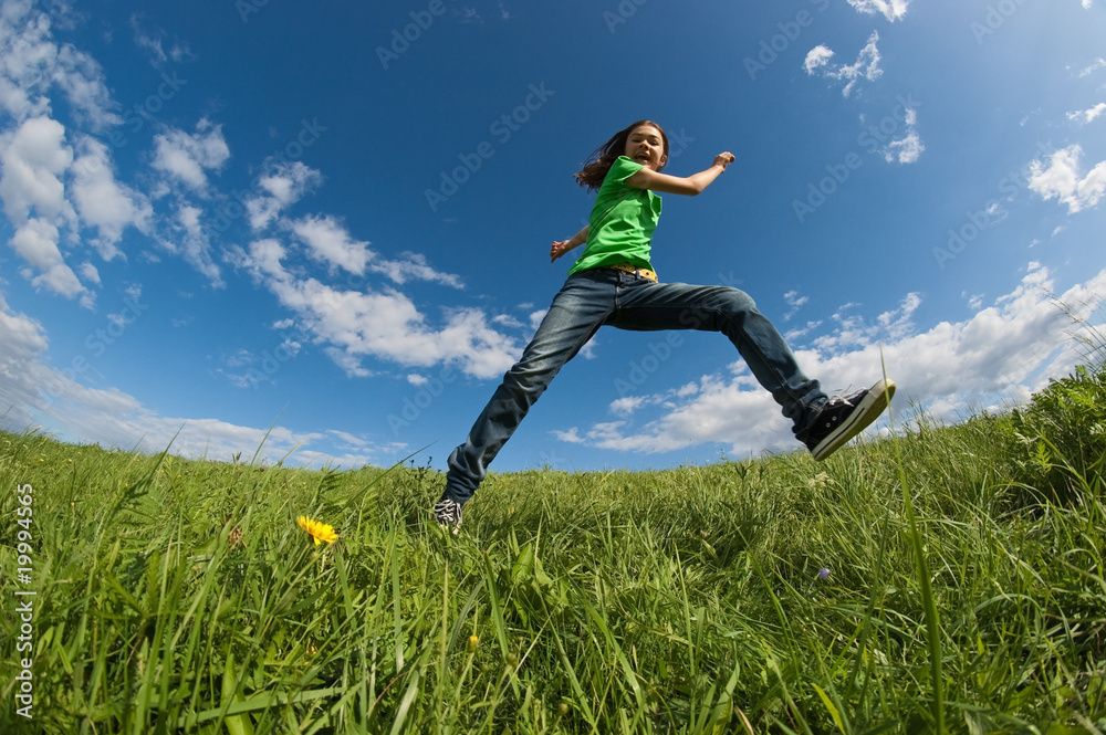 Girl running, jumping outdoor against blue sky Girl running, jumping outdoor against blue sky