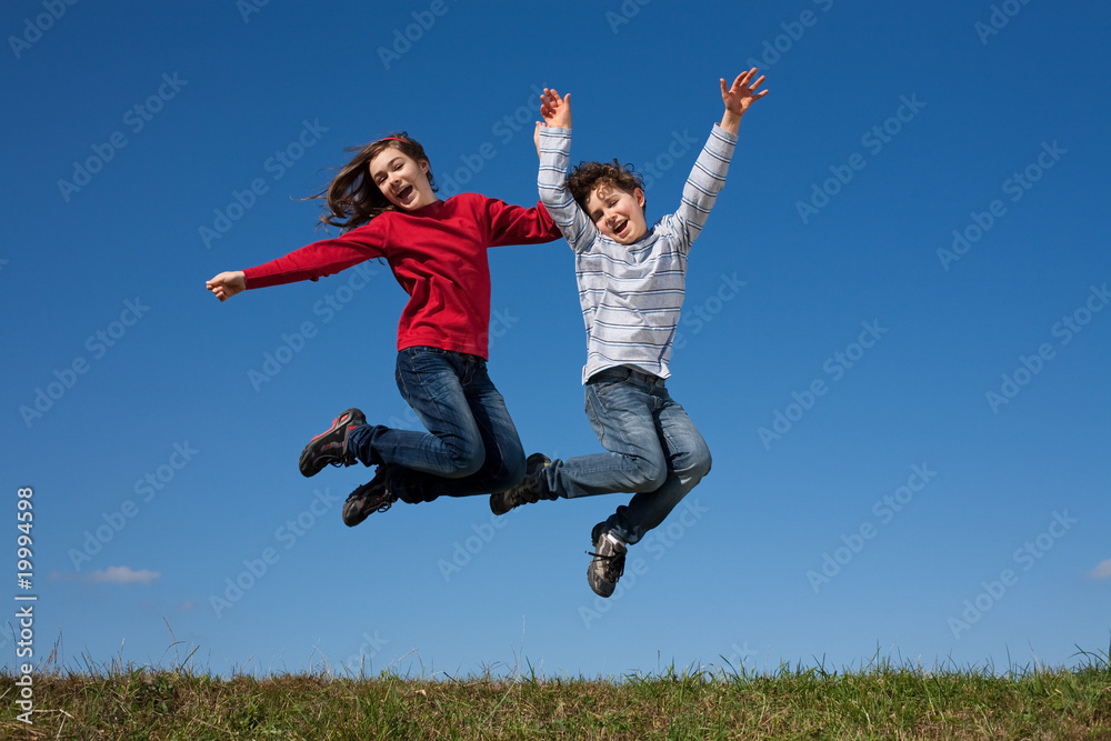 Kids jumping, running against blue sky Kids jumping, running against blue sky