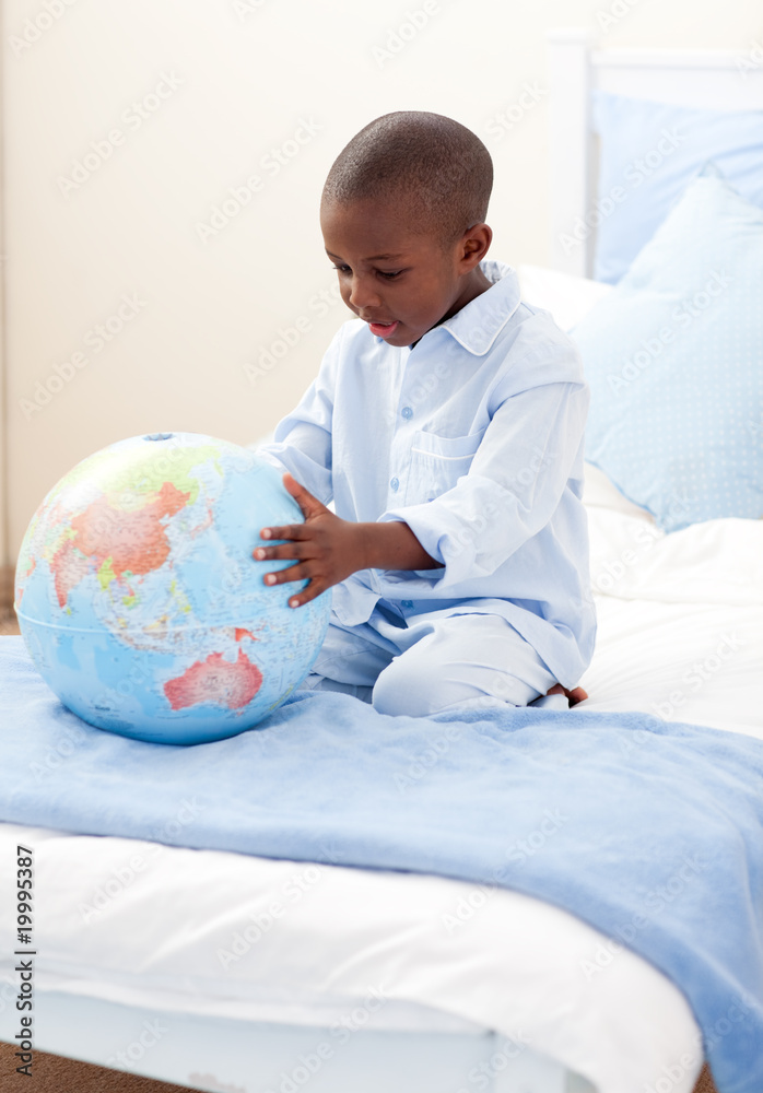 Little boy holding a terrestrial globe Little boy holding a terrestrial globe