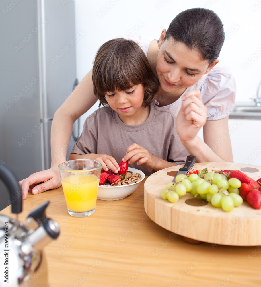 Smiling mother and her child having breakfast Smiling mother and her child having breakfast