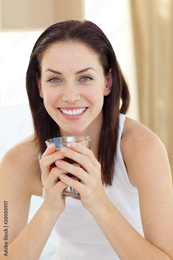 Smiling woman drinking tea