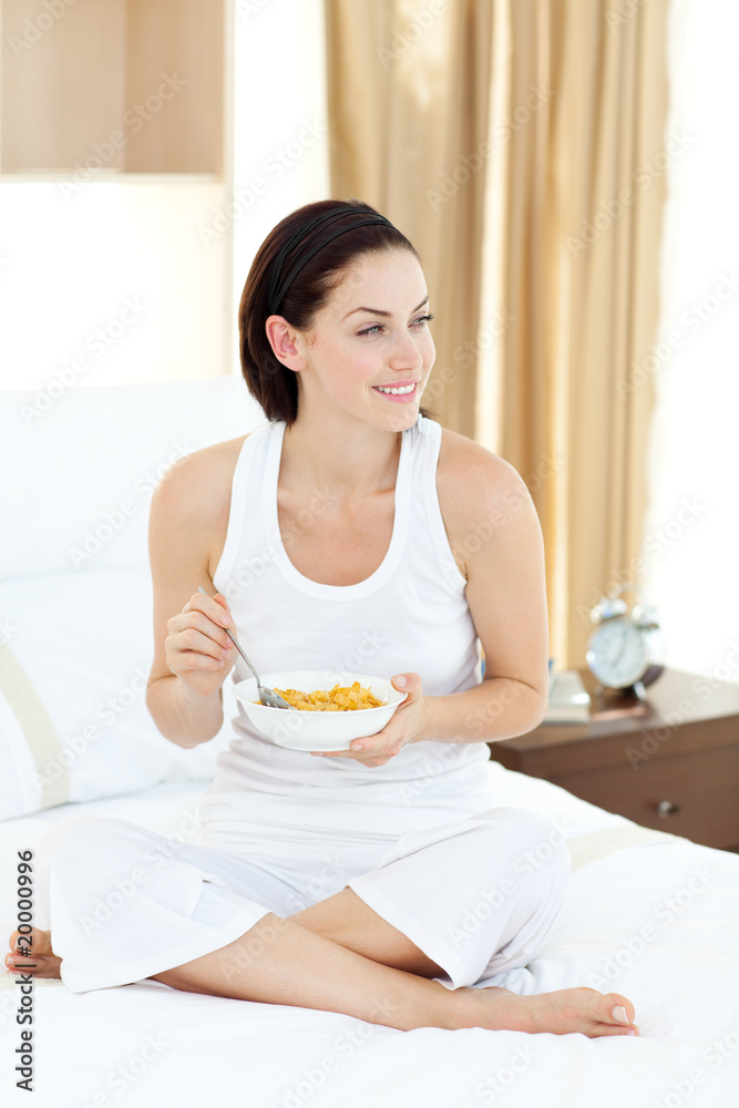 Smiling woman having breakfast