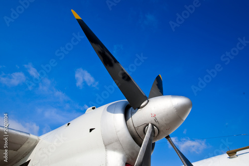 Black wings of an airplane motor in blue sky