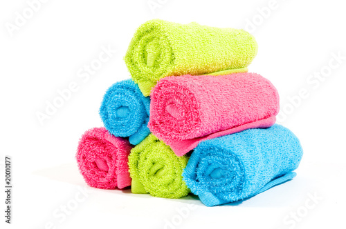 Colorful towel rolls on a white background © Ramona Smiers