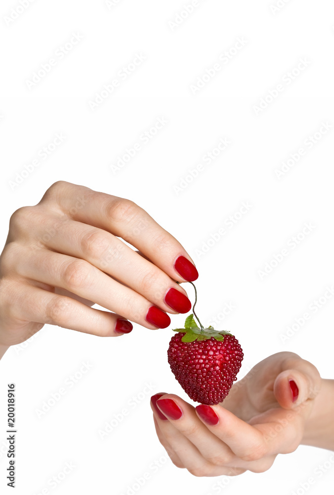 Obraz premium Woman hands with red manicure holding delicious strawberry