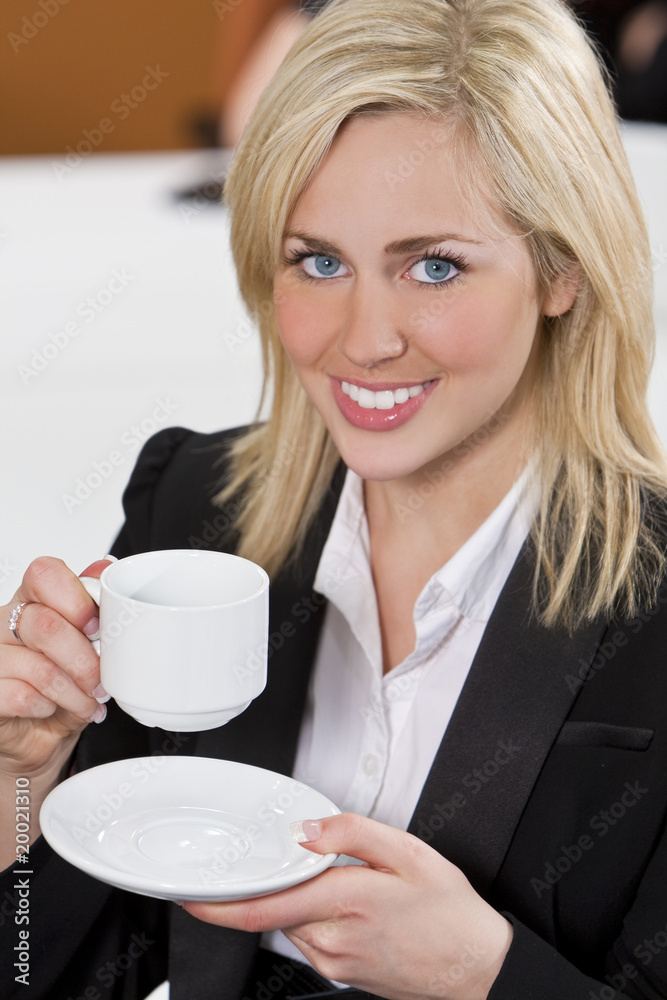 Happy Businesswoman Drinking Coffee In An Office Happy Businesswoman Drinking Coffee In An Office
