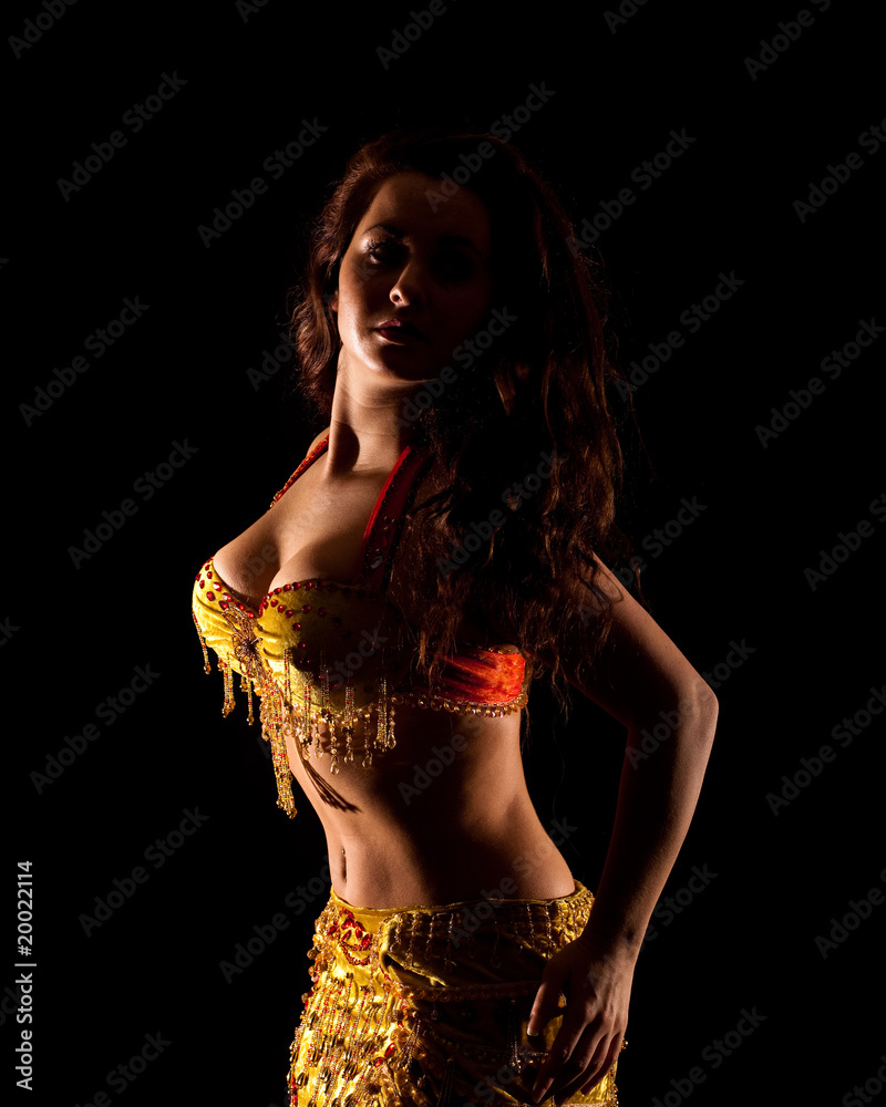 Fototapeta premium beautiful Bellydancer in golden costume, low key