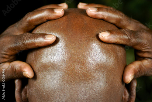 rear view of afro man with hands holding his head