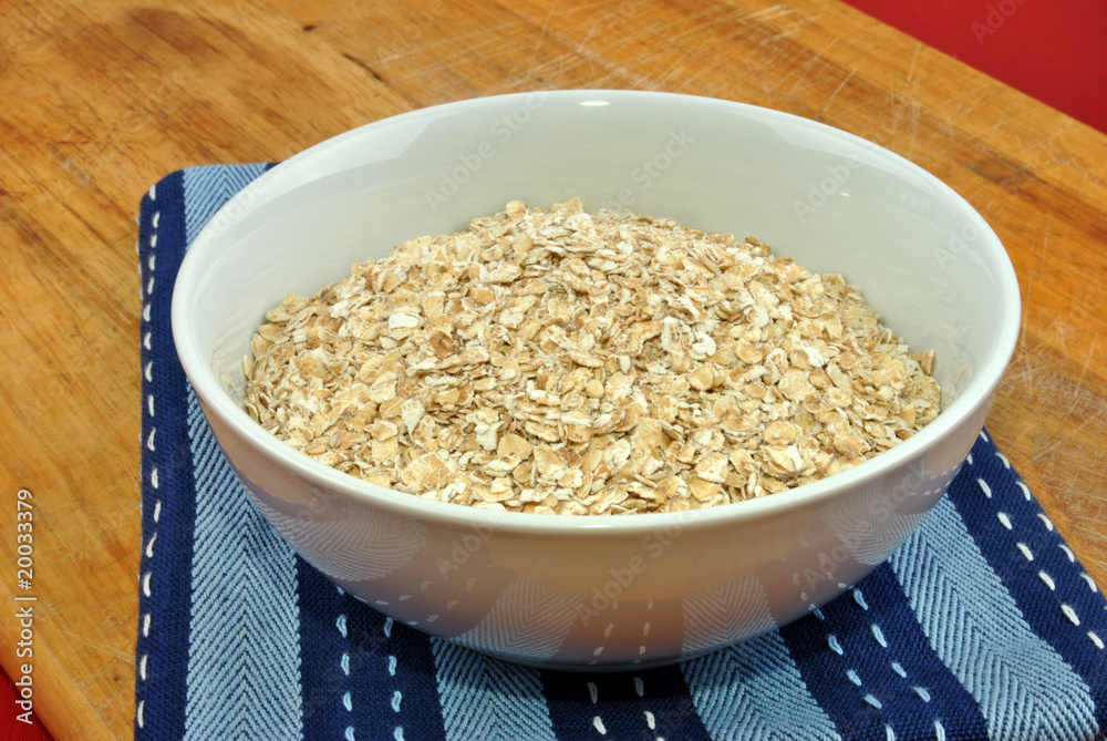 some organic oatmeal in a white bowl some organic oatmeal in a white bowl