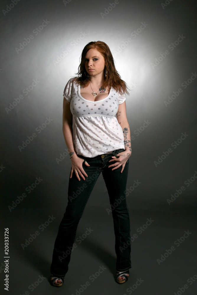 sassy looking young woman with tattoo and large breasts sassy looking young woman with tattoo and large breasts