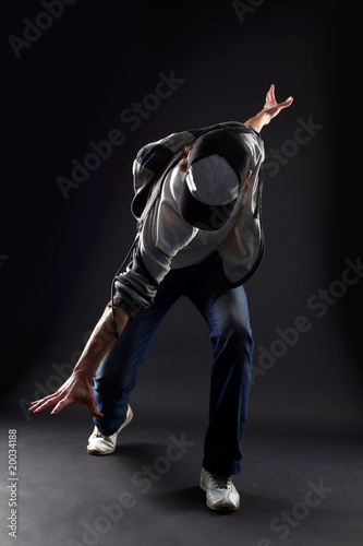 cool man modern dancer against black