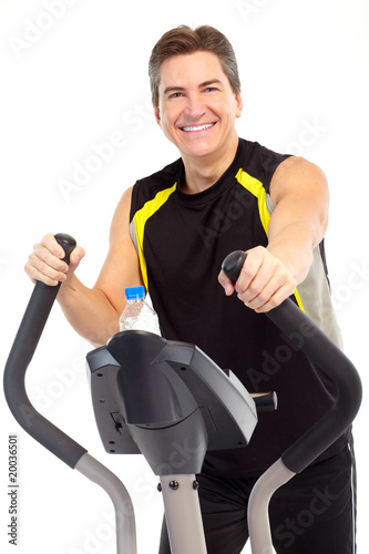 Smiling strong man working out. Isolated over white background.