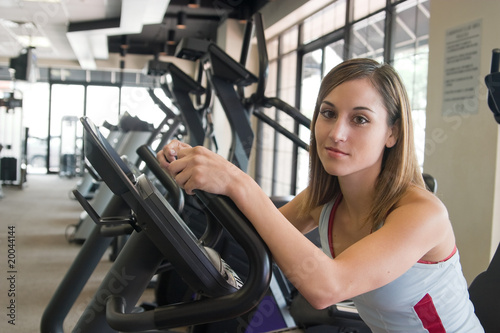 Woman Exercising On Stationary Cycle