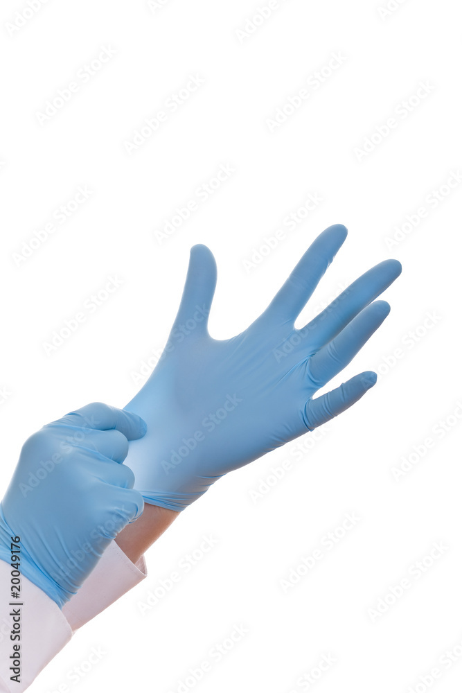 Hands of a medic in the blue latex gloves
