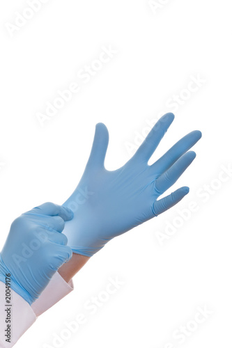 Hands of a medic in the blue latex gloves