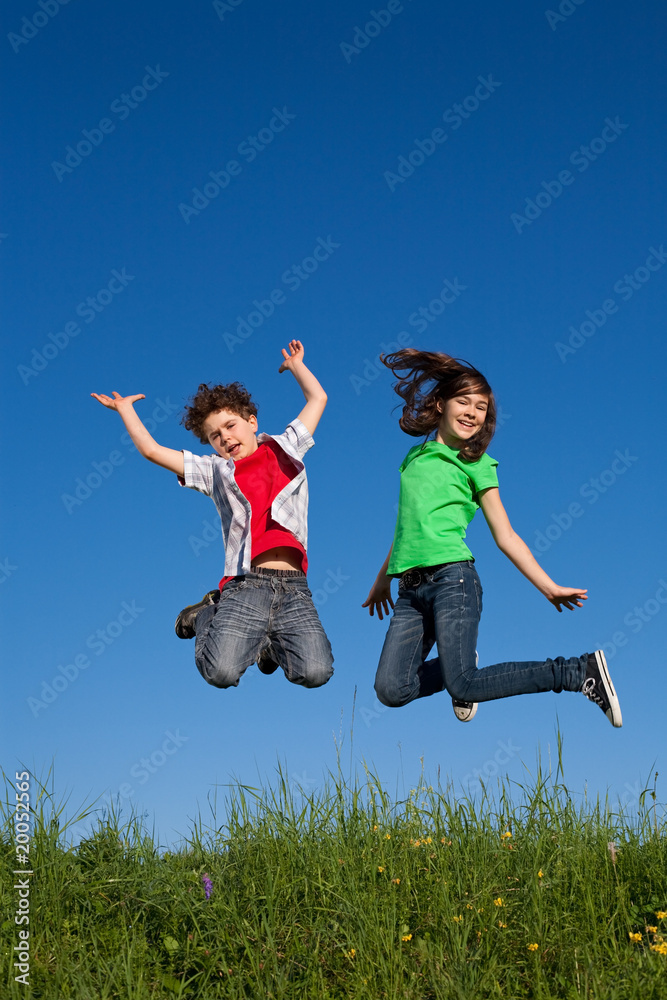 Kids jumping, running against blue sky Kids jumping, running against blue sky