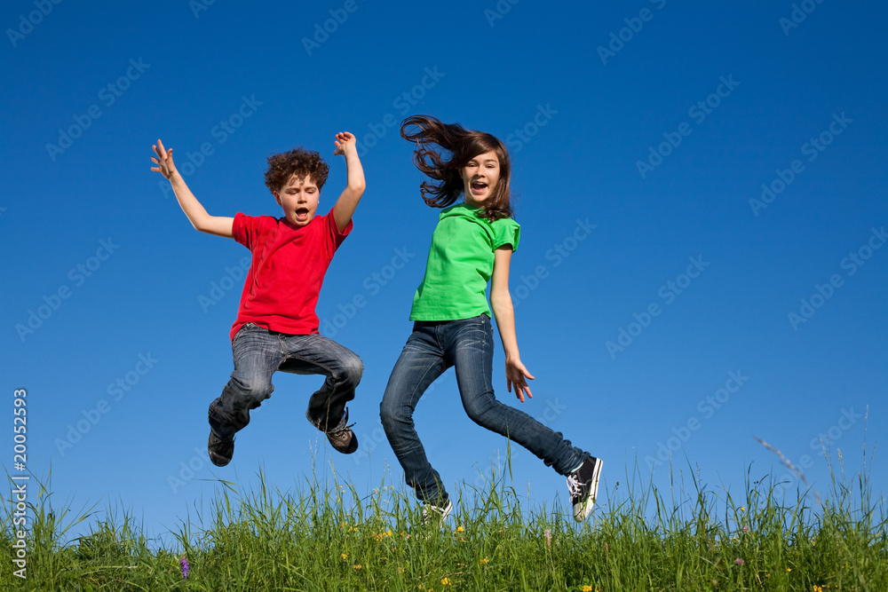 Kids jumping, running against blue sky Kids jumping, running against blue sky