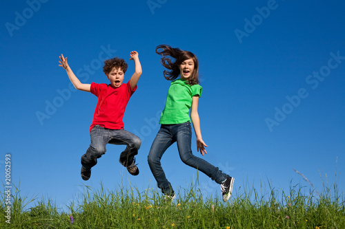 Kids jumping  running against blue sky