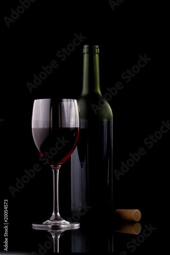 A glass of red wine and an empty glass