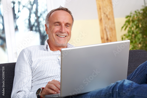 Mature man having fun with laptop