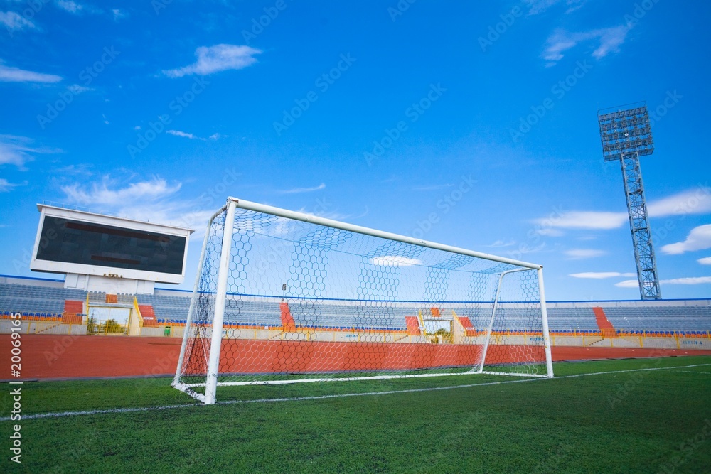 Obraz premium STADIUM - Football field with goal and tablo on blue sky
