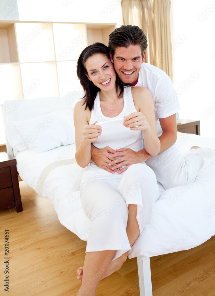 Jolly couple finding out results of a pregnancy test Jolly couple finding out results of a pregnancy test