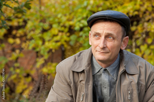 Thoughtful middleaged man in autumnal garden