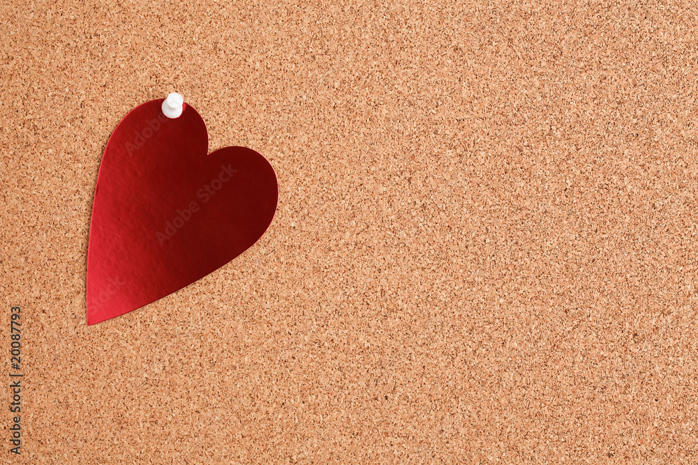 red heart on corkboard red heart on corkboard