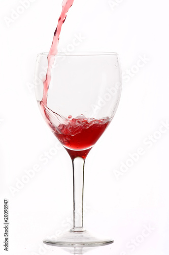 Red wine poured in a glass.