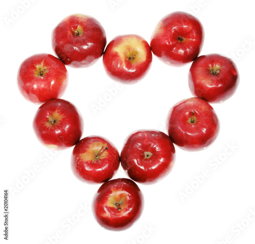 Heart of red apples on the white background