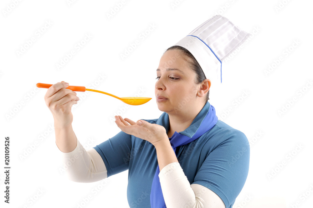 A female cook tasting the food she prepared. A female cook tasting the food she prepared.