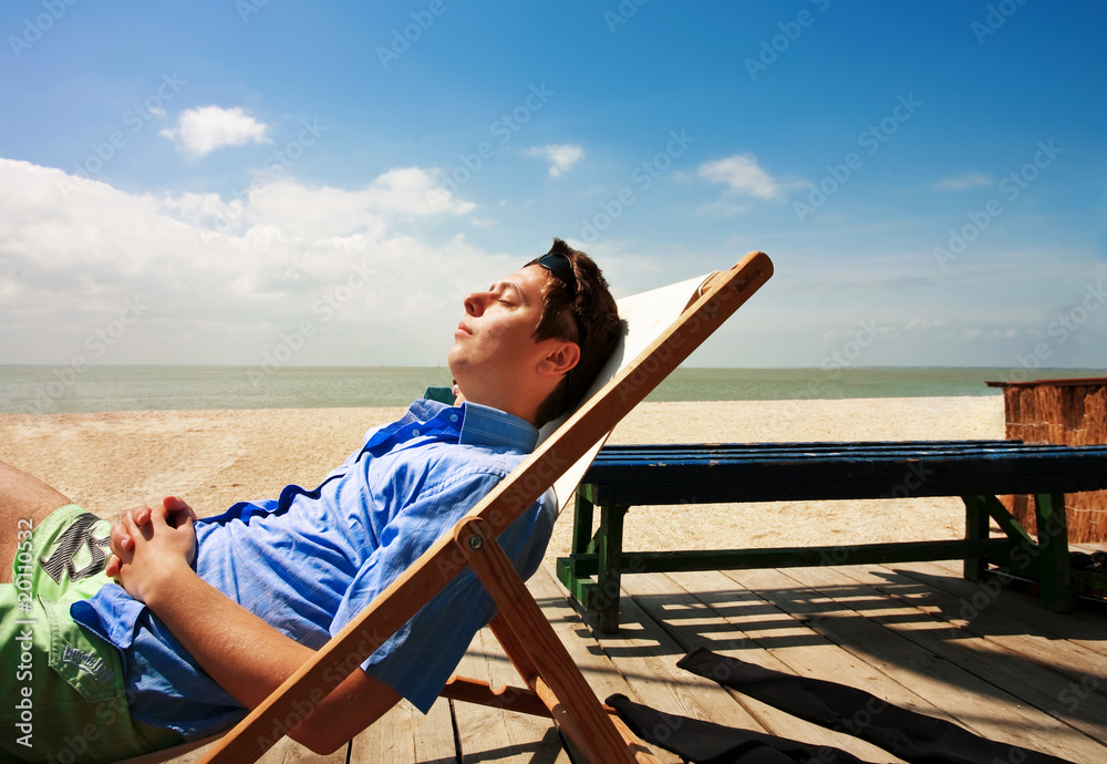 A young guy relaxing on the beach
