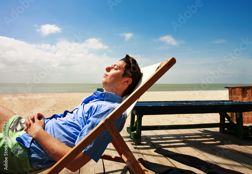 A young guy relaxing on the beach