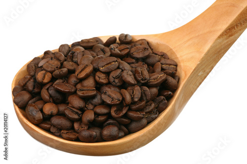 Coffee grains in a wooden spoon on a white background