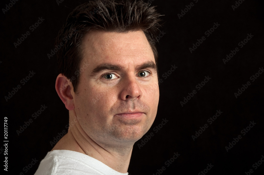 portrait of male in his 30's on black background portrait of male in his 30's on black background