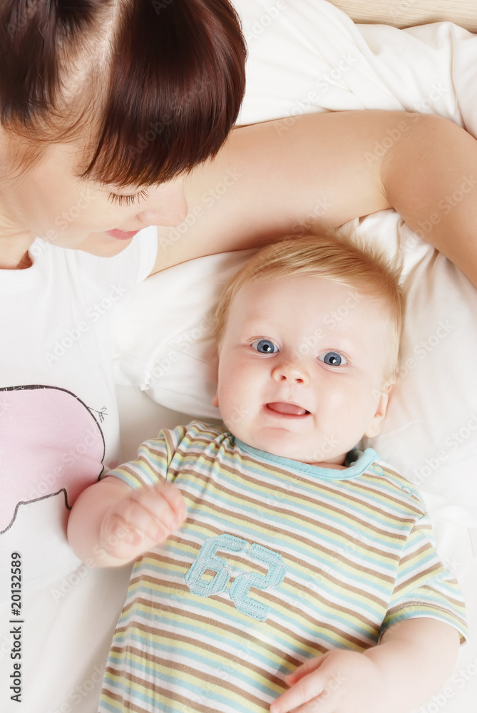 The little boy with mum on the bed The little boy with mum on the bed