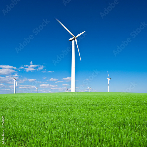 Wind power station - wind turbine against the blue sky