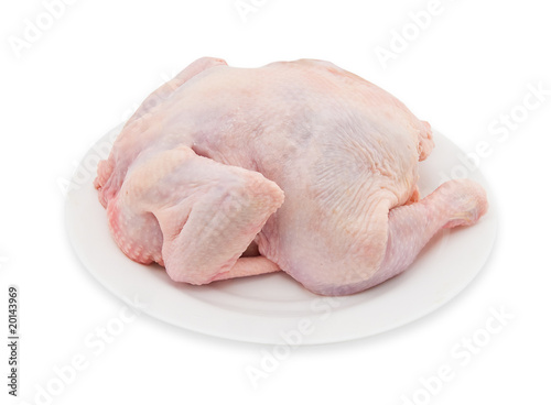 The crude cut chicken on a white plate