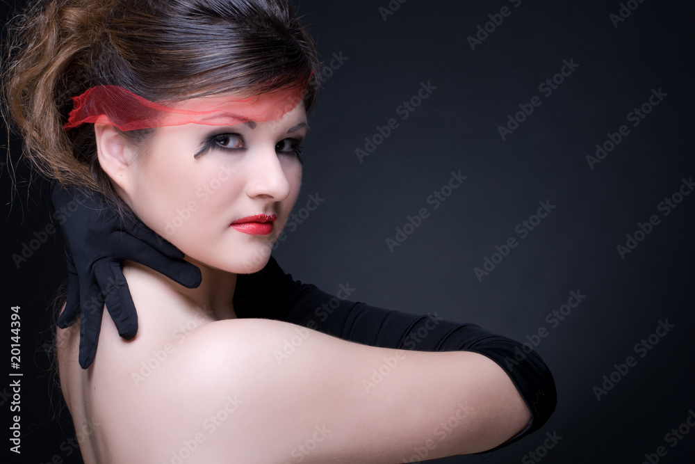 Fototapeta premium Close up portrait of girl with red lips on black
