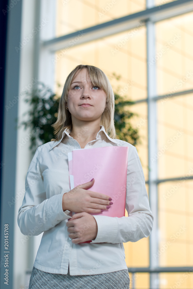 Young businesswoman with folder, paper in lobby Young businesswoman with folder, paper in lobby