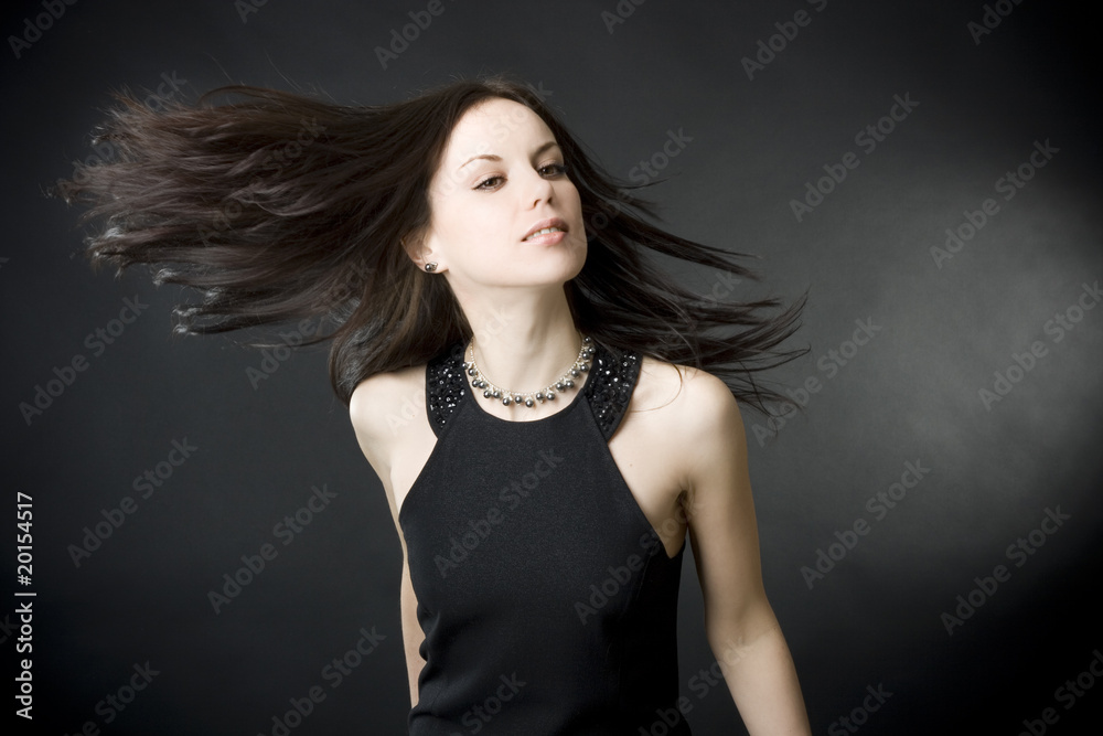 Naklejka premium beautiful young woman with flying hair