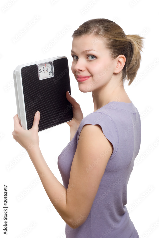 smiling young woman holding a weight scale smiling young woman holding a weight scale