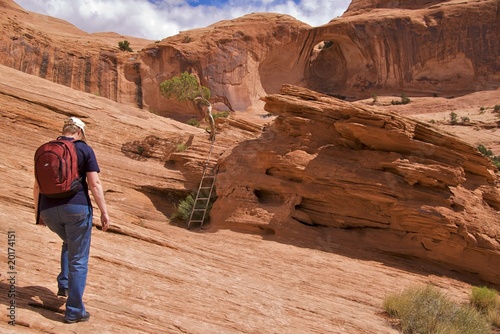 Hiker on Corona Arch Trail, Moab, just outside Arches NP