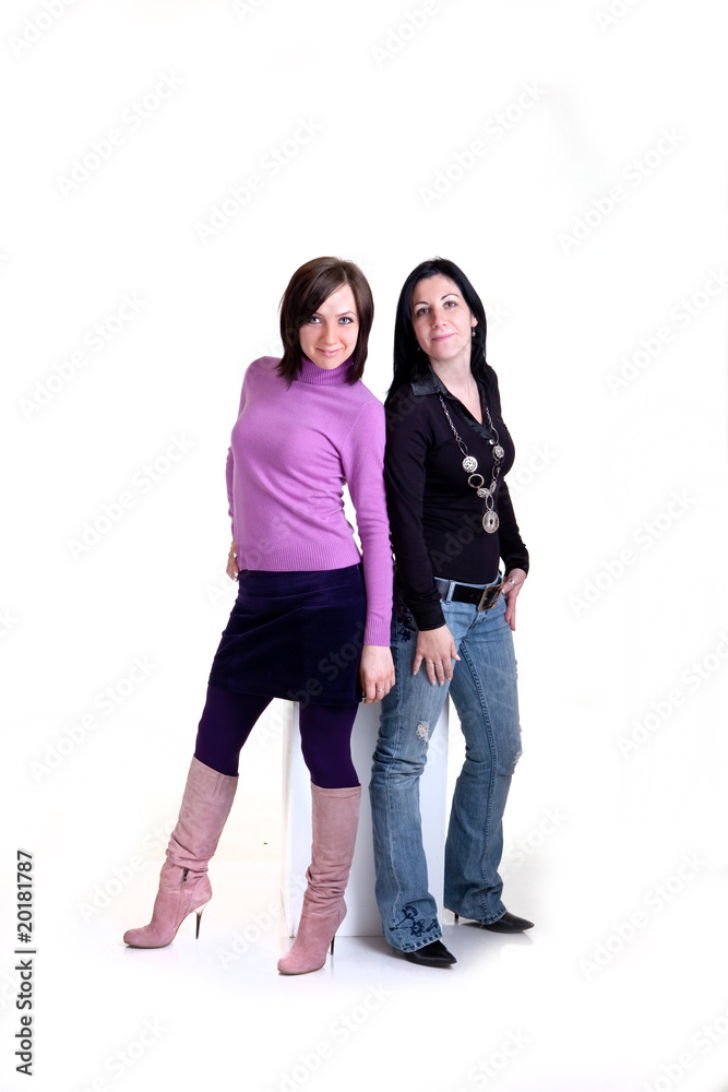 Girls are posing on a white cube