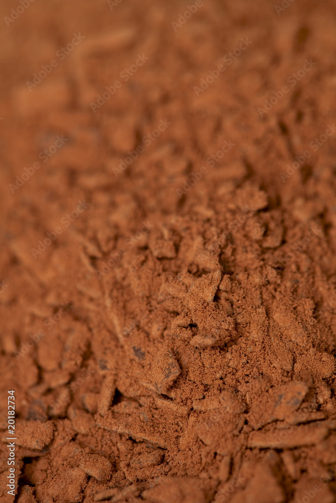 cocoa powder with small pieces of chocolate on background with s cocoa powder with small pieces of chocolate on background with s