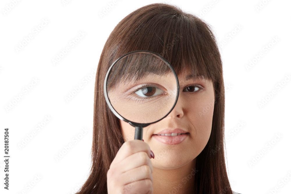 Businesswoman looking into a magniying glass Businesswoman looking into a magniying glass