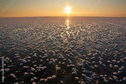 Sea in ice and snow in winter with sun © trancedrumer