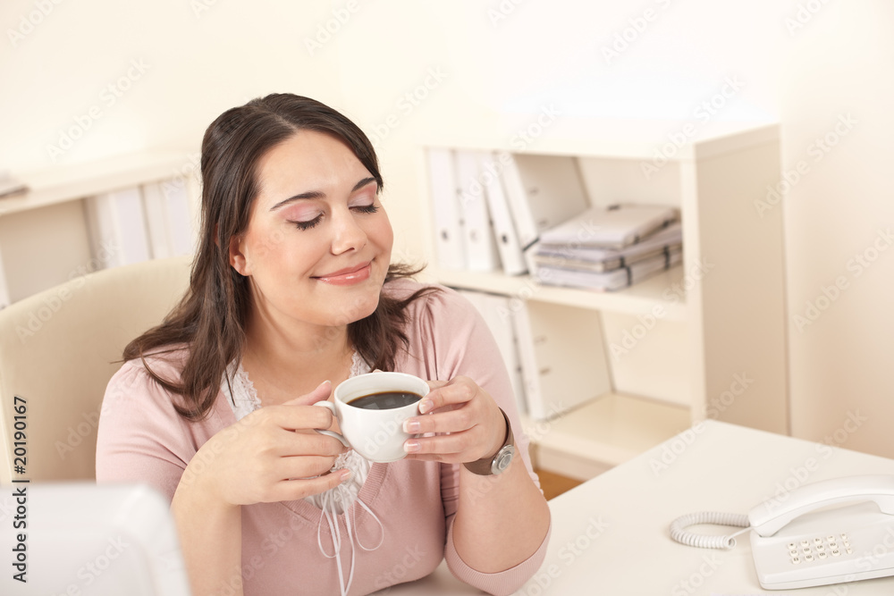 Young business woman enjoying coffee at modern office Young business woman enjoying coffee at modern office